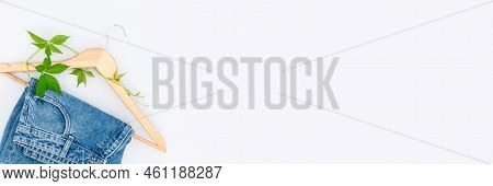Banner With Eco-friendly Shopping And Slow Fashion Concept. Upcycling Clothes. Jeans, Wooden Hangers