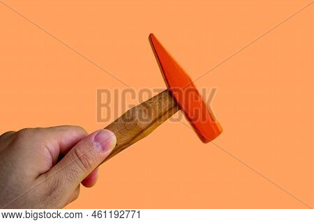Hand Held Wooden Handle Hammer And Orange Head, Isolated Orange Background, Straight Peen Hammer, Se