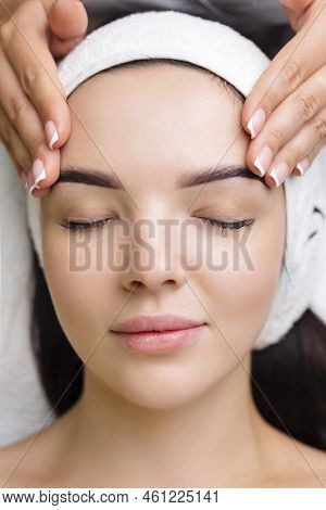 Professional Anti-aging Facial Massage. Action. Relaxing Facial Treatment At Spa. Relaxing And Rejuv