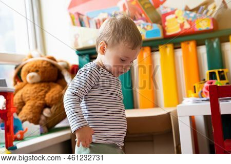 Toddler Boy Plays With Toys In The Children's Room. Educational Toys For Young Children. Child One A
