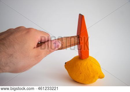 Hand Held Wooden Handle Hammer And Orange Head, On The Lemon, Isolated White Background, Straight Pe