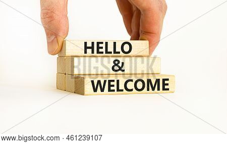 Hello And Welcome Symbol. Concept Words Hello And Welcome On Wooden Blocks. Businessman Hand. Beauti