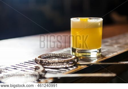 Whiskey Sour Cocktail - Bourbon With Lemon Juice, Sugar Syrup And Egg White. Cocktail Garnished With