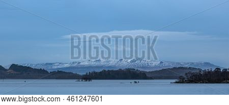 Stunning Landscape Image Of Loch Lomond And Snowcapped Mountain Range In Distance Viewed From Small 