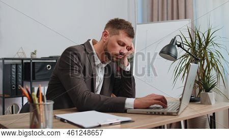 Bored Sleepy Business Man Worker Working On Laptop Computer, Yawning, Leaning On Hand Falling Asleep