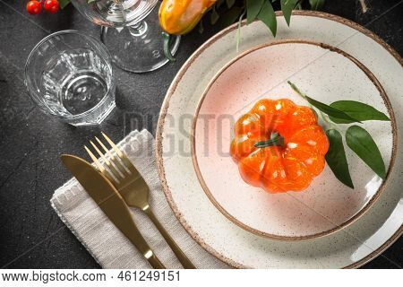 Autumn Table Setting With Plate, Cutlery, Pumpkin. Thanksgiving Food Festive Dinner. Top View At Bla