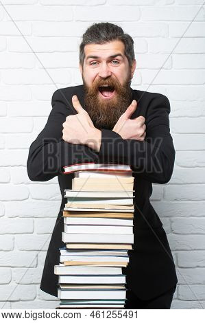 Portrait Of A Funny Teacher Or Professor With Book Stack. Thinking Serious Mature Teacher Near Educa