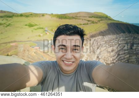 Adventurous Man Taking A Selfie At A Viewpoint. Close Up Of Person Taking An Adventure Selfie, Touri