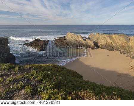 View Of Empty Praia Dos Buizinhos Sand Beach With Ocean Waves And Sharp Rock And Cllifs At Wild Vice