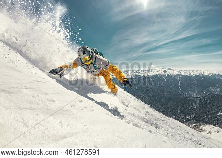 Real Professional Snowboarder Rides At Off-piste Ski Slope. Winter Sports Concept