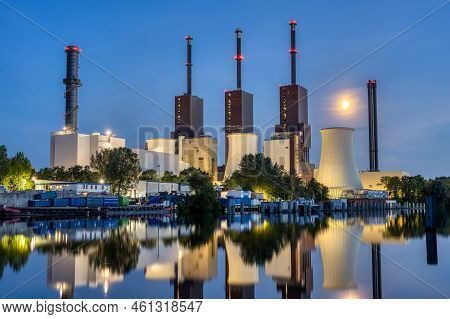 A Thermal Power Station In Berlin At Night Reflected In A Canal