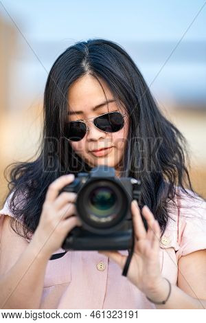 Amateur Sunglasses Asian Woman Take A Photo With Professional Mirrorless Camera At Outdoor Blue Roof