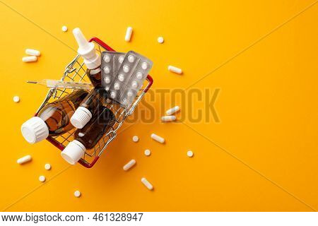 Healthcare Concept. Top View Photo Of Shopping Cart With Medicines Spray And Syrup Transparent Brown