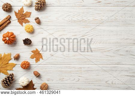 Thanksgiving Day Concept. Top View Photo Of Maple Leaves Pine Cones Acorns Small Pumpkins Walnut And