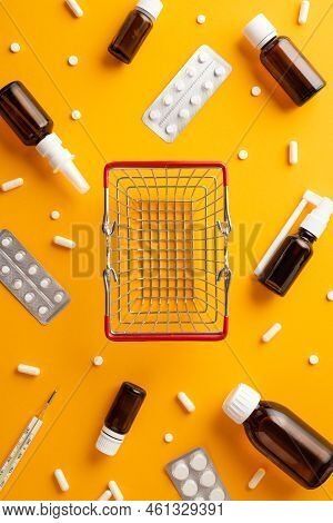 Healthcare Concept. Top View Vertical Photo Of Empty Shopping Cart Medicines Spray And Syrup Transpa