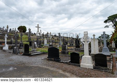 West Cork, Ireland, May 2, 2022. An Old Catholic Cemetery On A Cloudy Spring Day. Stone Tombstones. 