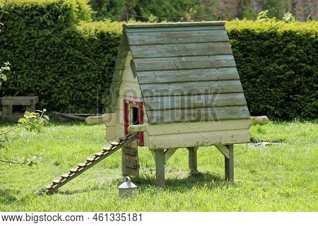 A Moveable Wooden Hen House In A Garden Orchard.