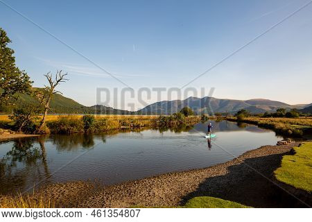 The Shore Of A Calm Lake In The Lake District On A Summer Sleepy Day