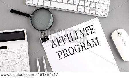 Affiliate Program Written On Paper With Office Tools And Keyboard On Grey Background