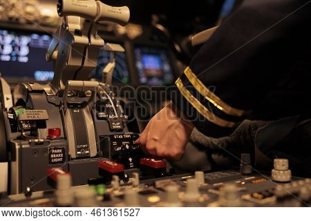 Female Copilot Pushing Dashboard Buttons In Plane Cockpit, Preparing To Takeoff With Engine Lever Or