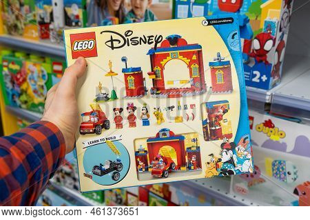 Lego Disney Constructor In A Customer's Hand. A Customer Takes A Box Of Lego From A Shelf In A Store