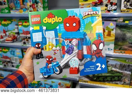 Lego Duplo Constructor In A Customer's Hand. A Customer Takes A Box Of Lego From A Shelf In A Store.