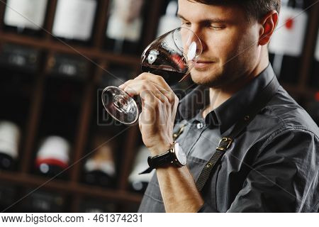 Bokal Of Red Wine On Background, Male Sommelier Appreciating Drink