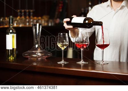 Sommelier Pouring Different Types Of Fine Wine