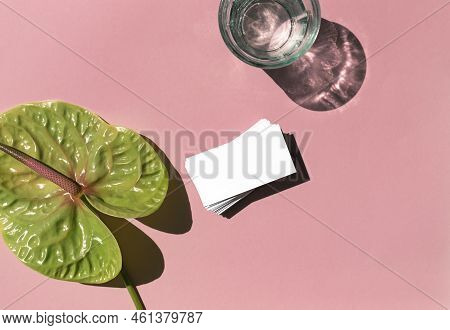 Business Card White Mosk Up On The Colorful Pink Background With Tropical Flower Flat Lay. Top View.