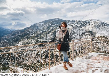 Young Woman Standing At Mountain Top Observation Deck Over Vouraikos Gorge. Mega Spileon Monastery T