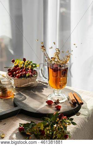 Rosehip Hearbal Tea Splash On Wooden Board. Vertical