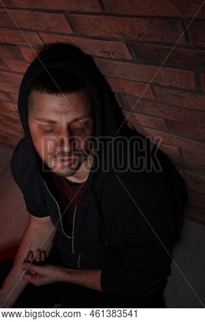 Overdosed Drug Addicted Man Near Brick Wall