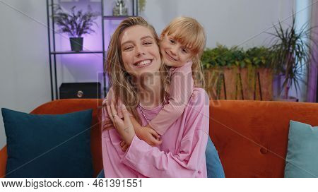 Pretty Smiling Cute Child Kid Daughter Embrace Mom Look At Camera. Happy Beautiful Family Young Adul
