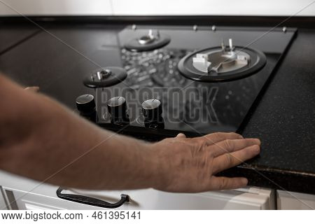 Installation Of A Gas Three-burner Built-in Stove In A Black Countertop. Kitchen Interier.