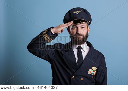 Confident Airplane Pilot Saluting, Wearing Uniform And Hat Front View Portrait, Plane Captain Lookin