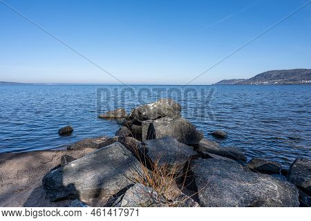 Boulders As A Part Of A Wave Breaker In A Lake. Picture From Lake Vattern, Sweden. Blue Water And Sk