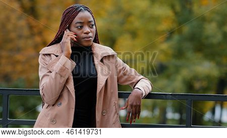 Young Confident Woman Standing Outdoors Talking On Telephone Answering Business Call Remotely Orders
