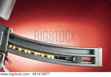 Rimfire Rifle Magazine Loaded With Ammo With Copy Space Above On A Red Background