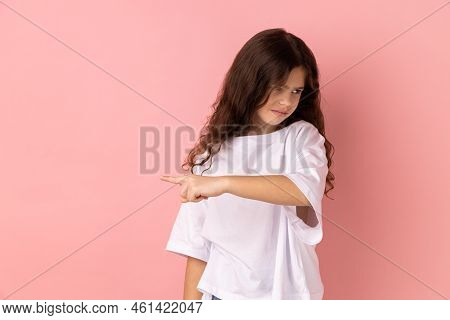 Get Out. Portrait Of Little Girl Wearing White T-shirt Showing Exit, Demanding To Leave Her Alone, T