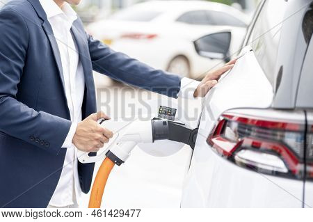 Chinese Electric Cars In Laos Plug Into Electrical Connectors To Charge Batteries Unknown Man Attach