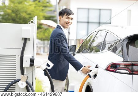 Chinese Electric Cars In Laos Plug Into Electrical Connectors To Charge Batteries Unknown Man Attach