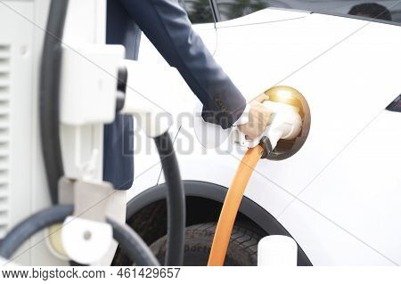 Chinese Electric Cars In Laos Plug Into Electrical Connectors To Charge Batteries Unknown Man Attach
