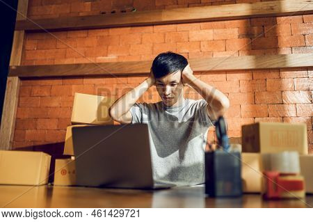 An Asian Man Uses A Mobile Phone To Take Orders And Display Items In A Box That Records Live Streami