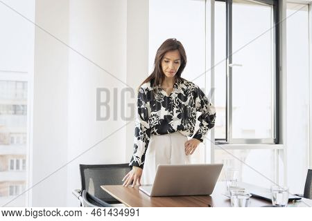 Shot Of Confident Businesswoman Feeling Stress While Sitting In A Modern Office And Working On Lapto