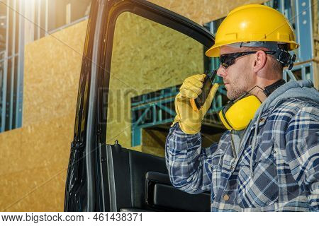 Closeup Of Caucasian Construction Site Supervisor Talking Through Shortwave Radio Transmitter With H