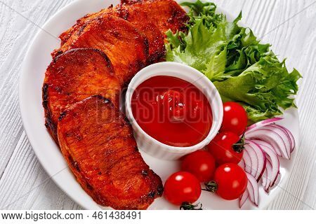 Close-up Of Grilled Slices Of Pork Loin Marinated In Paprika Based Sauce With Tomatoes And Lettuce, 