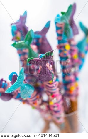 Mermaid Chocolate Pretzel Rods Drizzled With Pink And Purple Chocolate And Covered With Sprinkles.