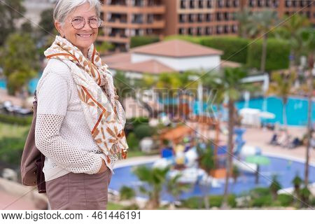 Smiling Beautiful Senior Woman With Eyeglasses Walking In Outdoor Excursion Enjoying Freedom And Vac