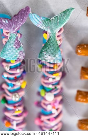 Mermaid Chocolate Pretzel Rods Drizzled With Pink And Purple Chocolate And Covered With Sprinkles.