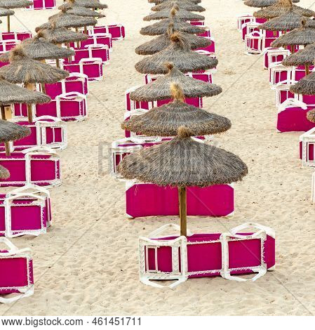 Red Beach Couch Ain The Morning At The Sandy Beach With Straw Parasols Waiting For First Tourists In